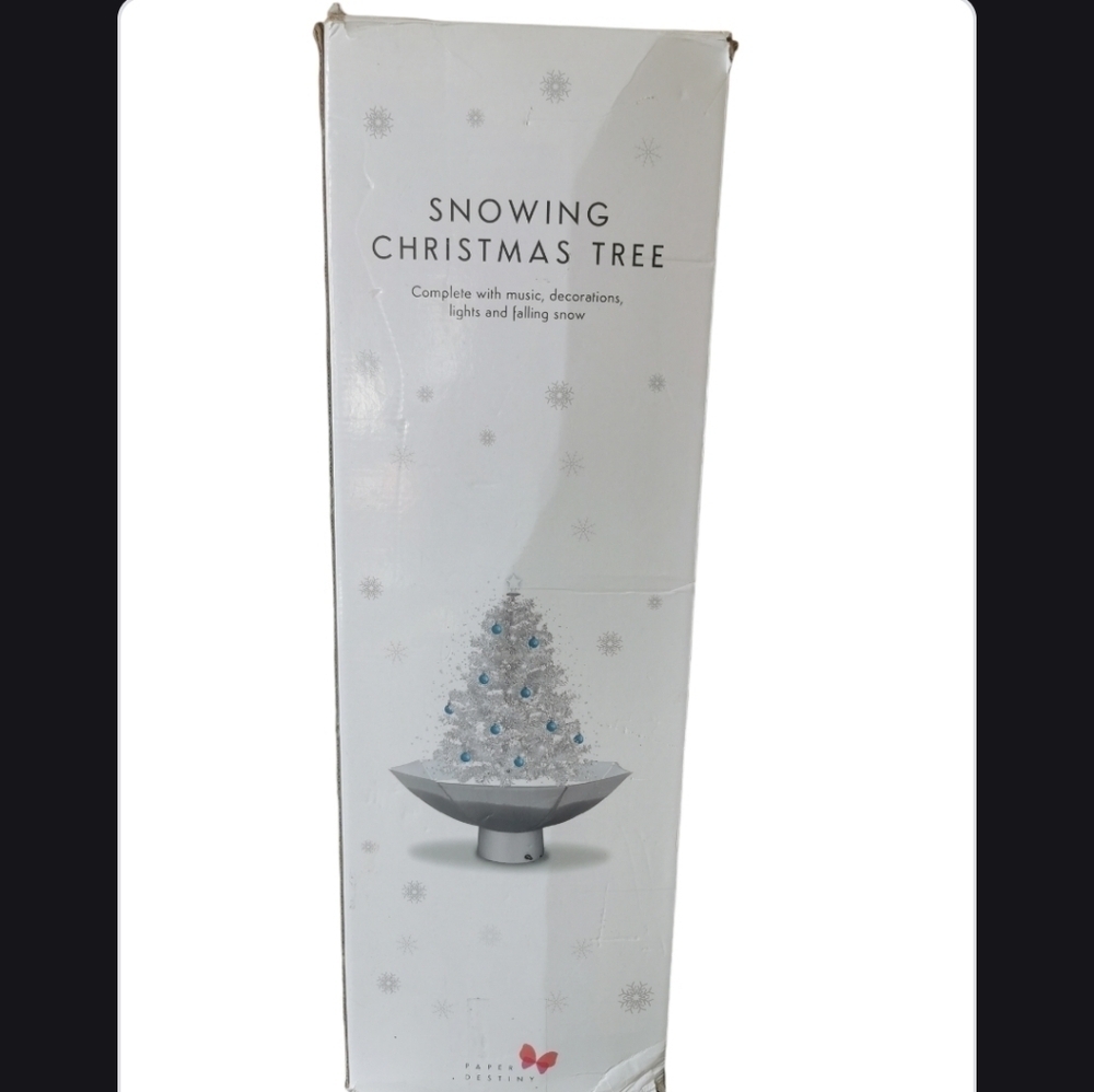 Snowing Christmas tree complete with decorations lights and falling snow